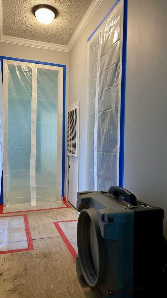 Containment barriers and negative air equipment set up on a job site